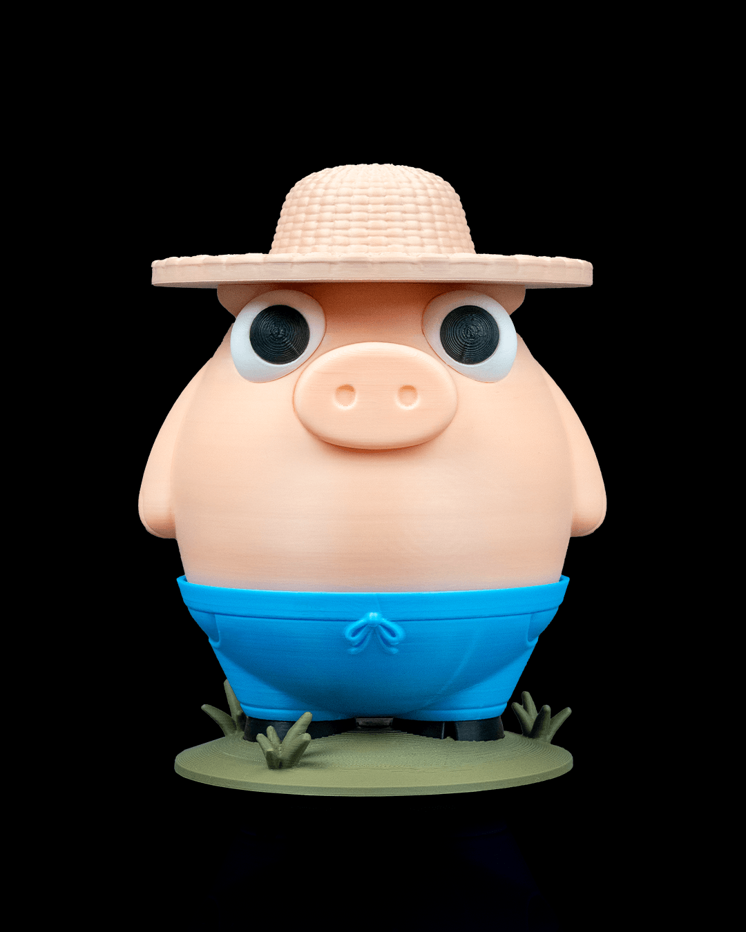 Cartoonish pig figurine wearing a straw hat and blue shorts on a black background