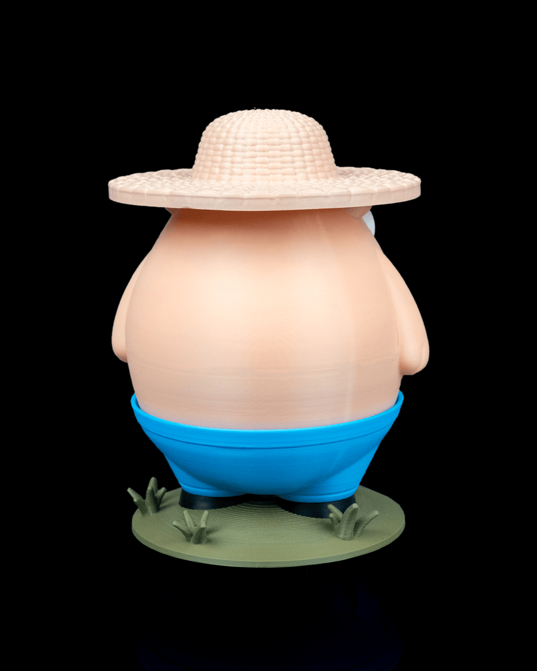 Cartoonish character with a large round body, blue shorts, and a wide-brimmed hat on a black background